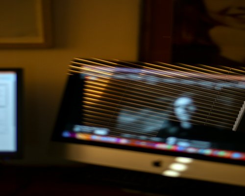 Close up of eye reflecting laptop screen light